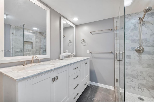 bathroom with vanity and a shower with door