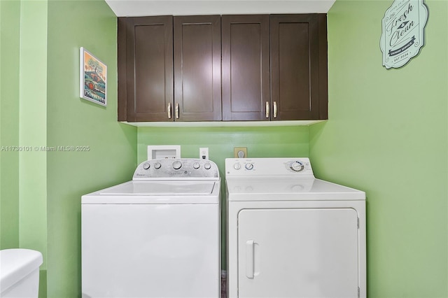 washroom featuring cabinets and separate washer and dryer