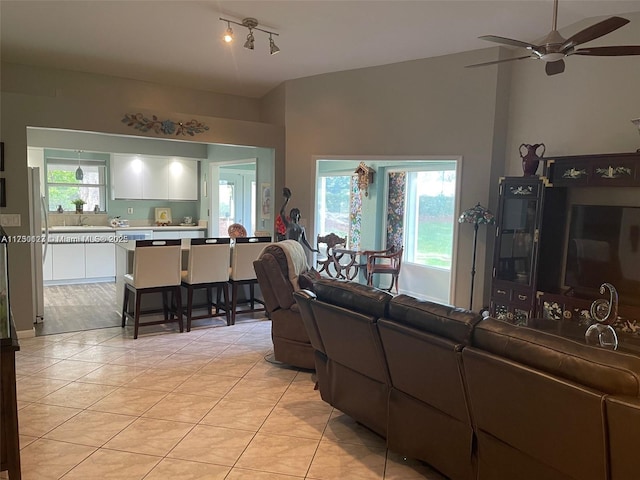 living room featuring ceiling fan and light tile patterned floors