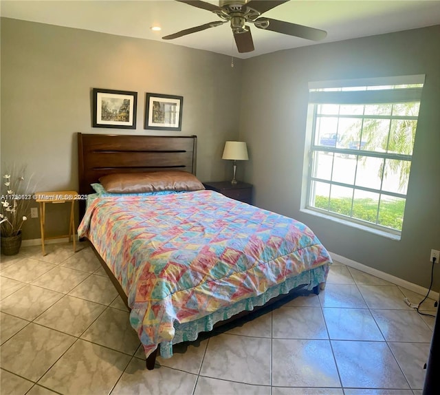 bedroom with ceiling fan and light tile patterned floors