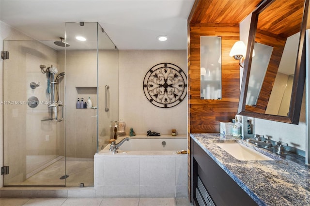 bathroom featuring plus walk in shower, tile patterned flooring, and vanity