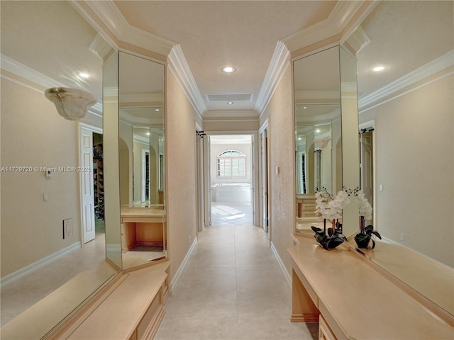 corridor featuring ornamental molding and light tile patterned flooring