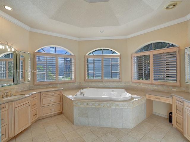 bathroom with crown molding, tile patterned floors, tiled bath, and vanity