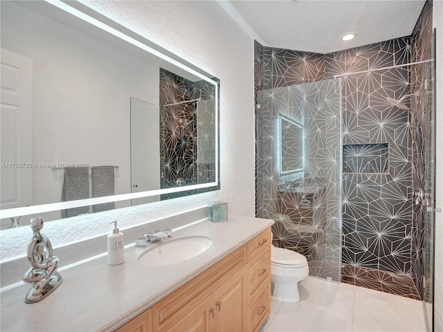 bathroom featuring vanity, tile patterned flooring, toilet, and walk in shower