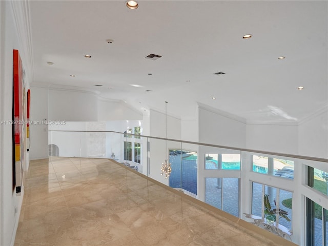 corridor featuring crown molding and high vaulted ceiling