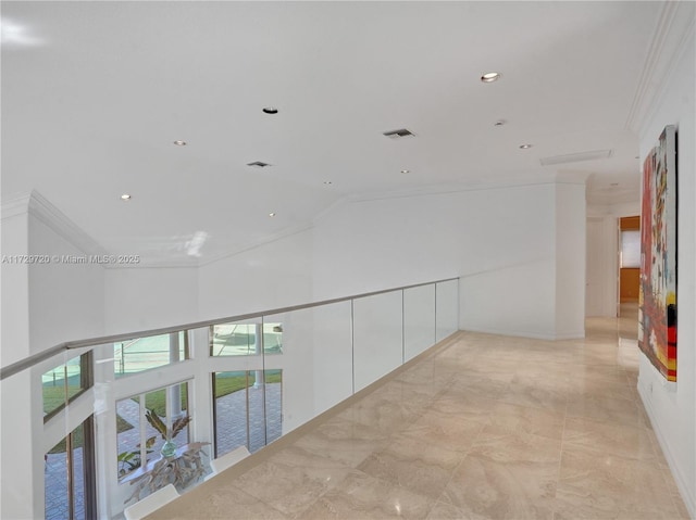 hall with crown molding and high vaulted ceiling