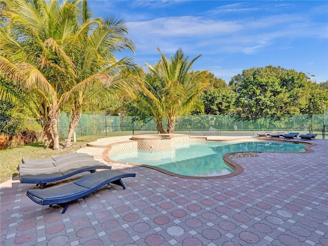 view of pool with a patio area and an in ground hot tub