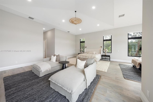 bedroom with high vaulted ceiling