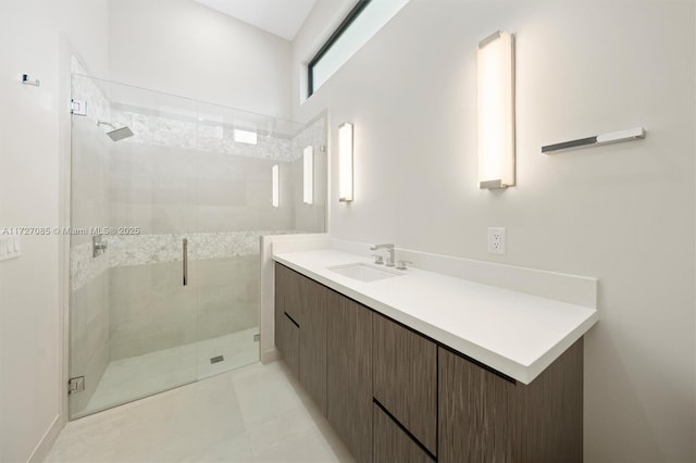 bathroom with a shower with door, tile patterned floors, and vanity