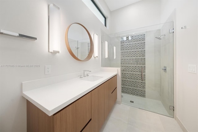 bathroom with vanity, tile patterned floors, and a shower with door