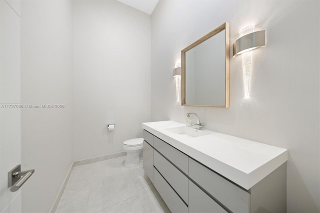 bathroom featuring toilet and vanity