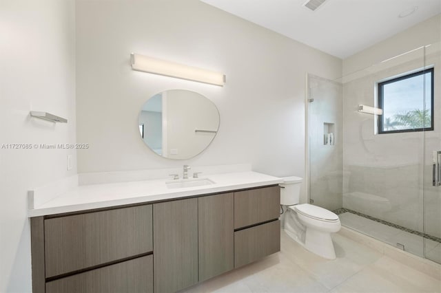 bathroom with a shower with door, toilet, vanity, and tile patterned flooring