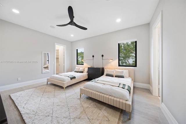 bedroom with light hardwood / wood-style flooring and ceiling fan