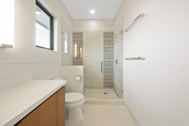 bathroom featuring toilet, walk in shower, vanity, and tile patterned flooring