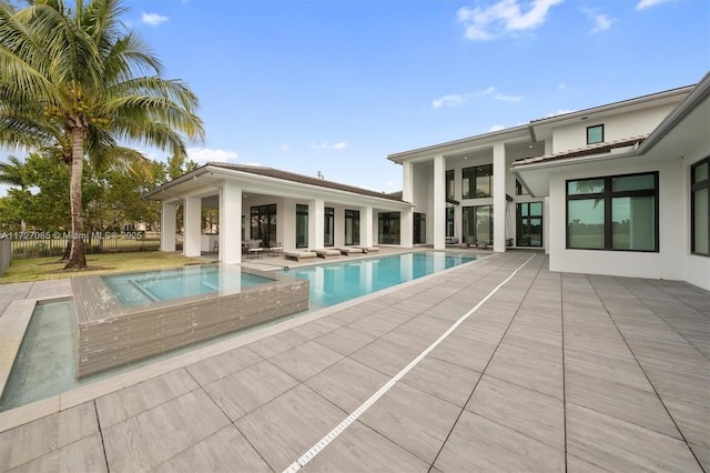 view of swimming pool with an in ground hot tub and a patio