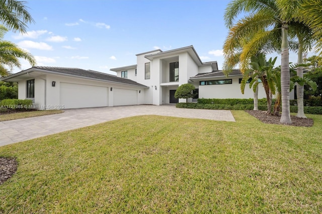 3275 Islewood Ave, Weston, FL 33332 - view of front facade featuring stucco siding, decorative driveway, an attached garage, and a front lawn