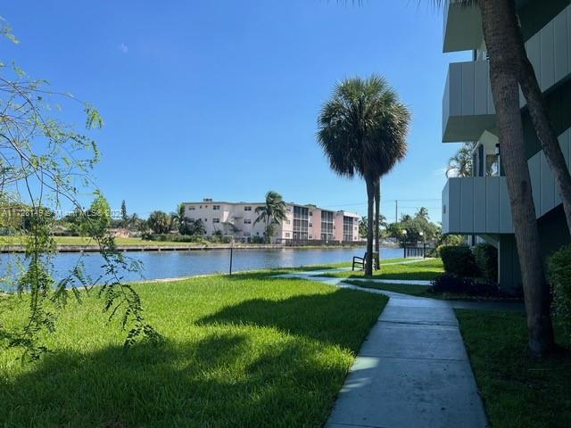 exterior space with a water view and a yard