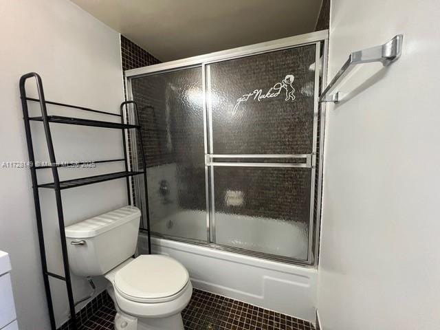 bathroom featuring shower / bath combination with glass door and toilet