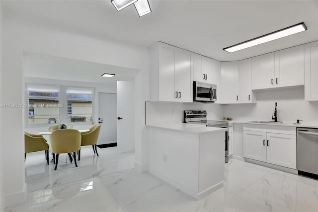 kitchen featuring white cabinetry, appliances with stainless steel finishes, and sink