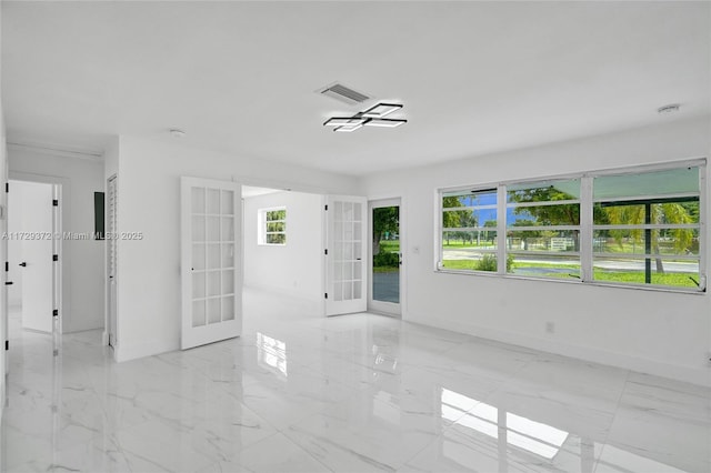 spare room featuring french doors