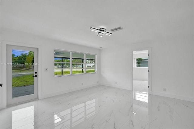 unfurnished room featuring plenty of natural light