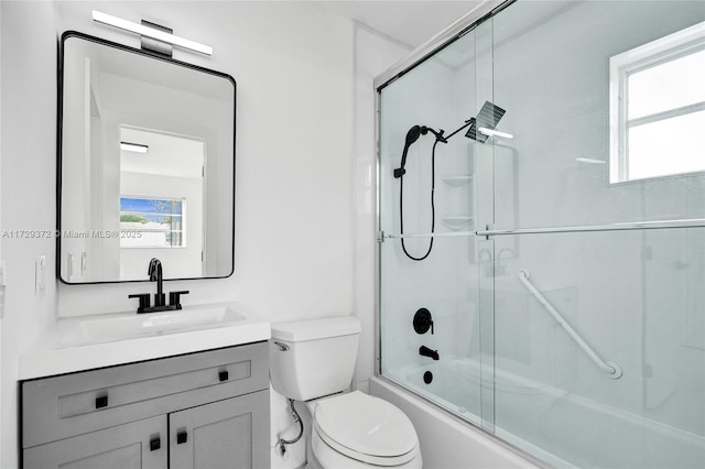 full bathroom featuring vanity, toilet, and combined bath / shower with glass door