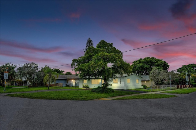 single story home with a lawn