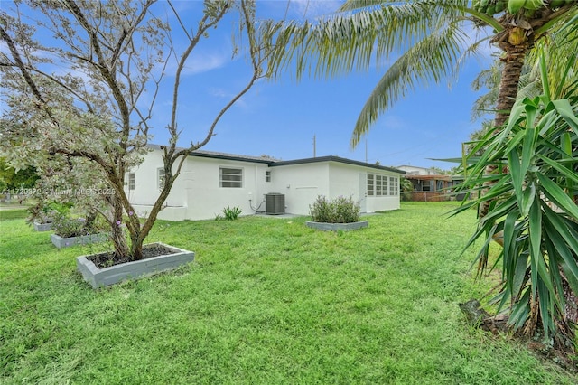 rear view of house featuring a lawn