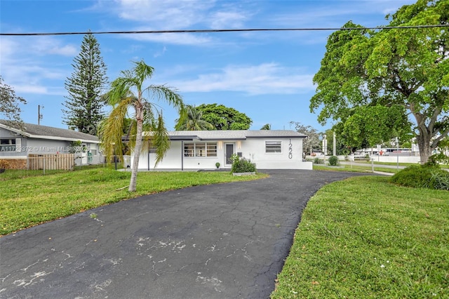 ranch-style home with a front yard