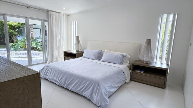 bedroom featuring access to outside and light tile patterned flooring