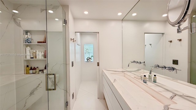 bathroom featuring vanity, a shower with door, and tile patterned flooring
