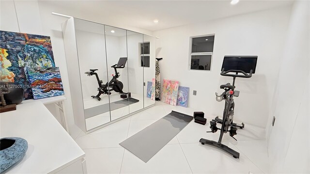 workout area featuring tile patterned flooring