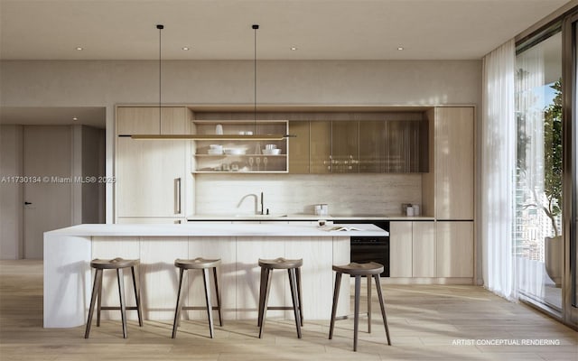 kitchen with light brown cabinetry, a kitchen breakfast bar, hanging light fixtures, sink, and light hardwood / wood-style floors