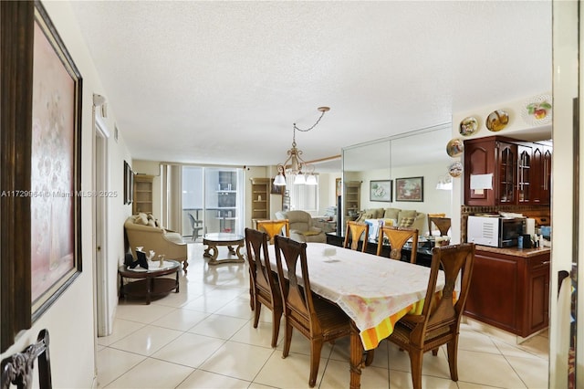 dining room featuring a textured ceiling and light tile patterned floors