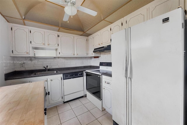 kitchen with sink, white cabinetry, light tile patterned floors, white appliances, and decorative backsplash