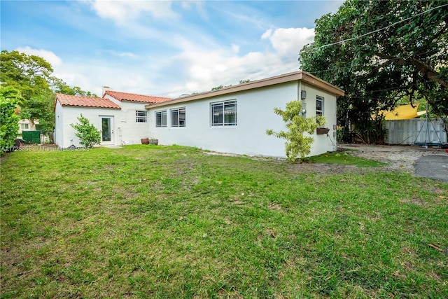 rear view of house with a yard