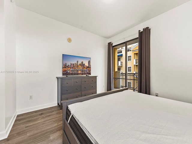 bedroom with dark hardwood / wood-style floors