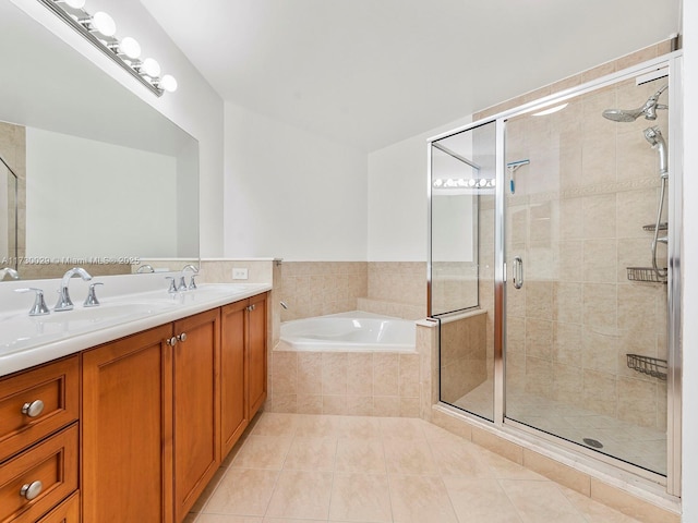 bathroom featuring independent shower and bath, tile patterned flooring, and vanity