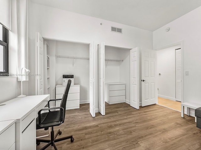 home office featuring separate washer and dryer and hardwood / wood-style floors