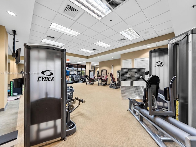 workout area with a paneled ceiling and carpet floors