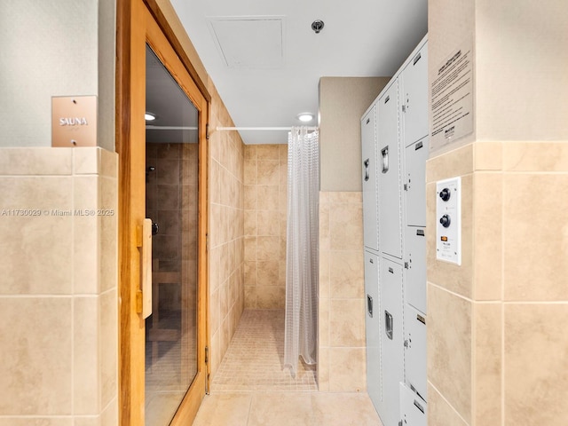 bathroom featuring tile patterned floors, tile walls, and a shower with curtain