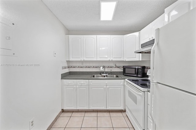 kitchen with white appliances, light tile patterned floors, sink, and white cabinets