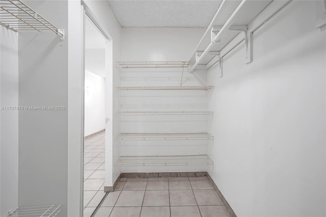 walk in closet featuring light tile patterned floors