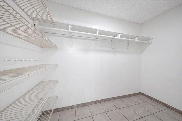 spacious closet with light tile patterned floors