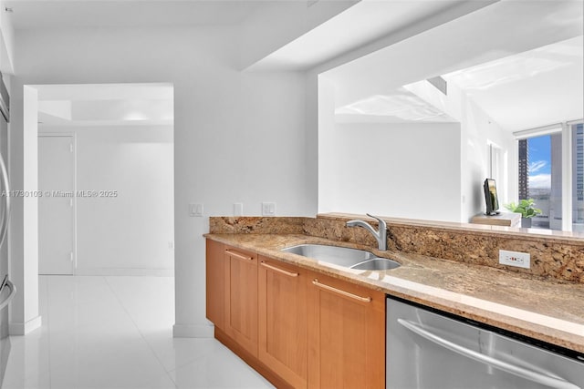 kitchen with dishwasher, sink, light stone countertops, and light tile patterned floors