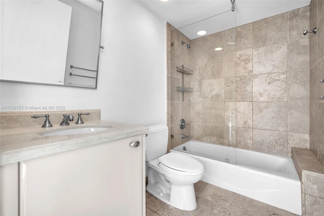 full bathroom with vanity, toilet, and tiled shower / bath