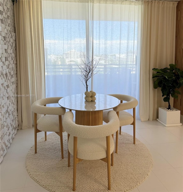 dining room with light tile patterned flooring and a healthy amount of sunlight