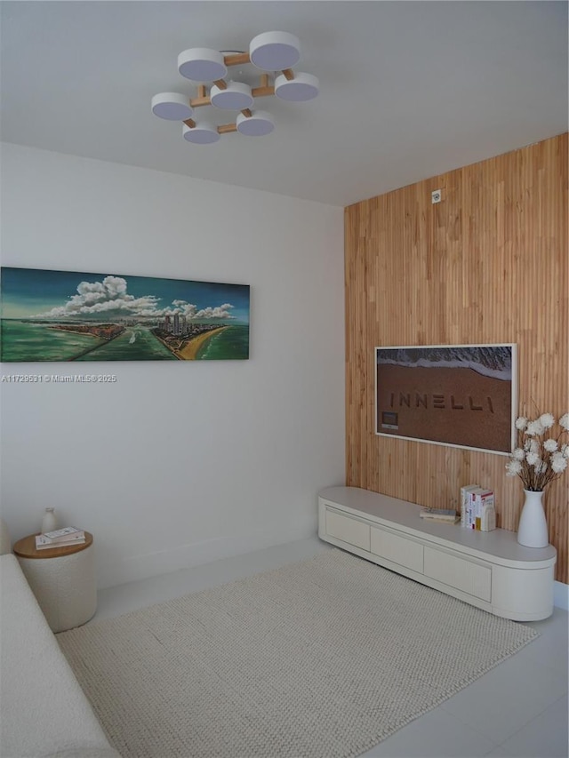 interior space featuring wood walls and an inviting chandelier