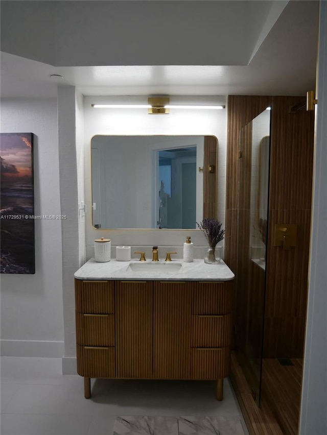 bathroom with a shower with shower door and vanity