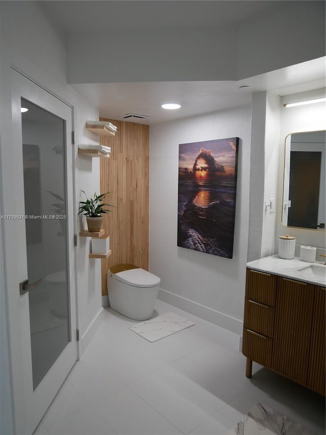 bathroom featuring vanity, toilet, and wood walls